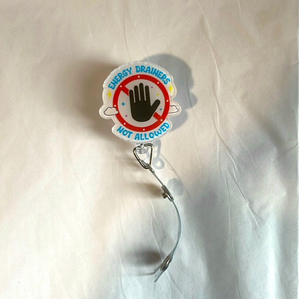 “Energy drainers not allowed” retractable badge, reel